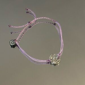 Pura Vida Lavender Adjustable Cord Bracelet with Silver Sunburst Design.